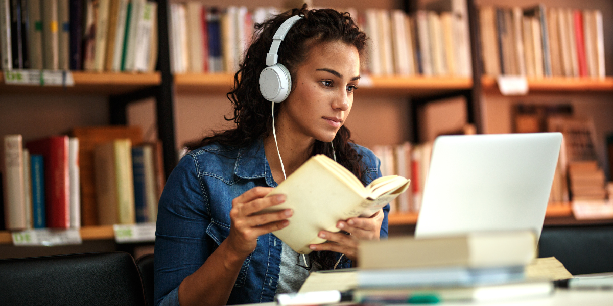 An individual studying remotely at an open university, using a laptop at home to access flexible online courses in Canada.