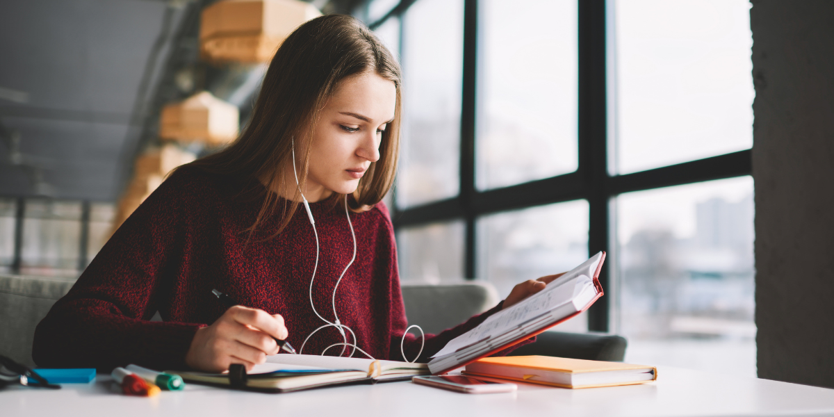 A student engaging in remote learning for an open university program, working from home on a laptop to achieve academic goals.