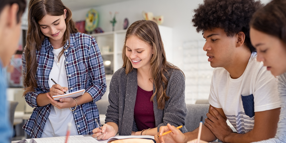 A group of teenagers deeply focused on their studies, demonstrating how fostering an interest in education keeps students motivated and eager to explore new subjects.