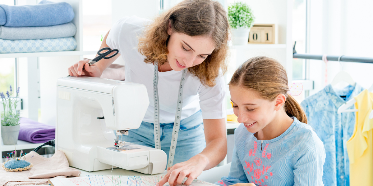 Two teenagers practicing sewing techniques, demonstrating how the benefits of home economics extend to creativity, problem-solving, and even future career opportunities.