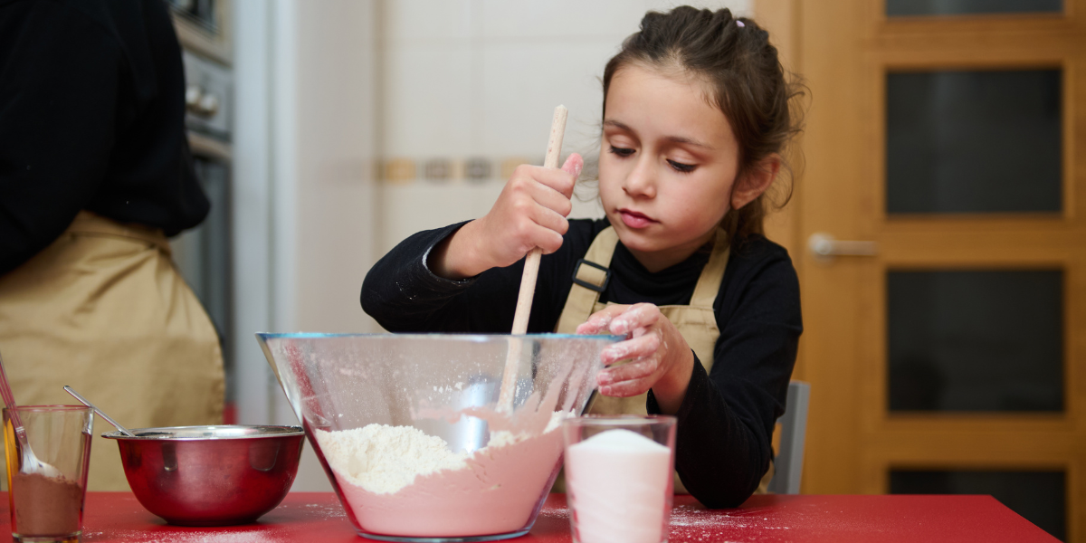 A young child learning to cook, showcasing how home economics builds confidence, independence, and essential nutritional skills for lifelong success.