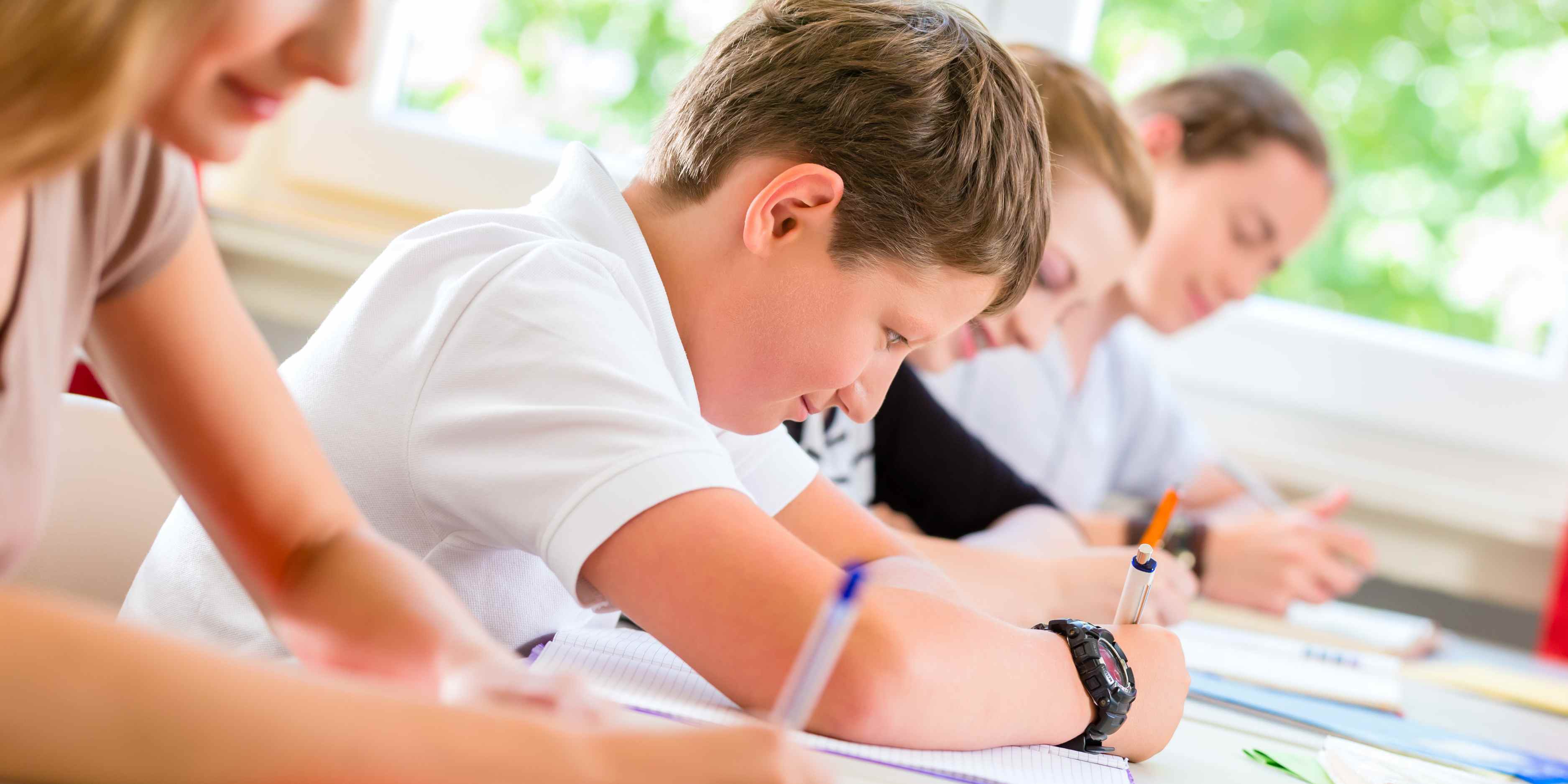 Child calmly taking a test in a classroom, focused and confident during exam time.